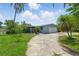 Single-story home with a gray exterior, an attached garage and a large concrete driveway at 4101 Shore Acres Ne Blvd, St Petersburg, FL 33703