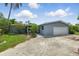 Single-story home with a gray exterior, an attached garage and a large concrete driveway at 4101 Shore Acres Ne Blvd, St Petersburg, FL 33703
