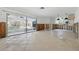 Spacious open-concept living area connecting to the kitchen and screened-in pool area via sliding glass doors at 4101 Shore Acres Ne Blvd, St Petersburg, FL 33703
