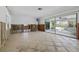 Expansive living room showcases an open floor plan with sliding glass doors to the pool area at 4101 Shore Acres Ne Blvd, St Petersburg, FL 33703