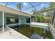 Screened-in pool area with algae-filled pool needing maintenance and potential refurbishment at 4101 Shore Acres Ne Blvd, St Petersburg, FL 33703