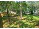 A shaded backyard with wood fencing and well-maintained landscaping at 4167 Seton Cir, Palm Harbor, FL 34683