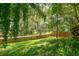 Wood fence surrounds large backyard with beautiful trees and landscaping at 4167 Seton Cir, Palm Harbor, FL 34683