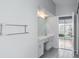 Bathroom featuring double sinks and access to screened-in patio at 4167 Seton Cir, Palm Harbor, FL 34683