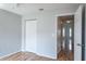 Bedroom featuring wood floors, neutral walls, double door closet and door to hallway at 4167 Seton Cir, Palm Harbor, FL 34683