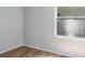 Bedroom featuring wood floors and natural light from a large window at 4167 Seton Cir, Palm Harbor, FL 34683