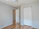 Bedroom featuring wood floors, neutral walls, double door closet and door to hallway at 4167 Seton Cir, Palm Harbor, FL 34683