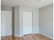 Bedroom featuring wood floors, neutral walls and double door closet at 4167 Seton Cir, Palm Harbor, FL 34683