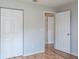 Bedroom featuring wood floors, neutral walls, double door closet and door to hallway at 4167 Seton Cir, Palm Harbor, FL 34683
