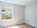 Bright bedroom featuring wood floors and natural light from a large window at 4167 Seton Cir, Palm Harbor, FL 34683