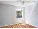 Bedroom featuring wood floors and natural light from a large window at 4167 Seton Cir, Palm Harbor, FL 34683