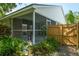 View of exterior showing screened patio and fenced backyard at 4167 Seton Cir, Palm Harbor, FL 34683