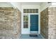 Inviting front entrance with a blue door and sidelight windows at 4167 Seton Cir, Palm Harbor, FL 34683