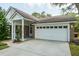 Attached two-car garage with white door and well-kept brick exterior at 4167 Seton Cir, Palm Harbor, FL 34683