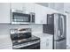 Modern kitchen featuring stainless steel appliances and white cabinetry at 4167 Seton Cir, Palm Harbor, FL 34683