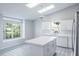 Bright kitchen with island, tile floors, and plenty of natural light at 4167 Seton Cir, Palm Harbor, FL 34683