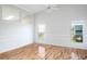 Open living area with hardwood flooring, white walls and abundant natural light at 4167 Seton Cir, Palm Harbor, FL 34683