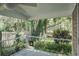 Relaxing screened patio boasting ceiling fan with views of the lush fenced backyard at 4167 Seton Cir, Palm Harbor, FL 34683