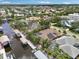 Aerial view of a waterfront home featuring solar panels, a private dock, and a screened-in pool area at 4615 Shark Dr, Bradenton, FL 34208