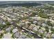 A wide aerial view showcases a waterfront community with winding canals, boat docks, and beautiful residences at 4615 Shark Dr, Bradenton, FL 34208