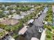This aerial captures a waterfront community with canals, boat docks, and homes surrounded by lush greenery at 4615 Shark Dr, Bradenton, FL 34208