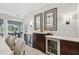 A dry bar is adjacent to an open floor plan with decorative mirrors and wine coolers for entertaining at 4615 Shark Dr, Bradenton, FL 34208