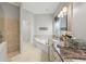 Bright bathroom featuring granite countertops, tub, and separate glass shower at 4615 Shark Dr, Bradenton, FL 34208