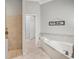 Bright bathroom featuring a tub, a shower, and tile floors at 4615 Shark Dr, Bradenton, FL 34208