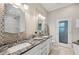 Bathroom with double vanity, granite countertop, and mosaic tile backsplash at 4615 Shark Dr, Bradenton, FL 34208