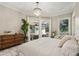 Bedroom with sliding doors to patio, chandelier, and wood floors at 4615 Shark Dr, Bradenton, FL 34208