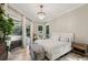 Bright bedroom with a chandelier, sliding doors to a patio, and wood flooring at 4615 Shark Dr, Bradenton, FL 34208