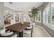 Bright dining room featuring a modern chandelier, neutral walls, and large windows with plantation shutters at 4615 Shark Dr, Bradenton, FL 34208