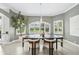 Elegant dining room with modern lighting, large windows, and views of the landscaped yard at 4615 Shark Dr, Bradenton, FL 34208