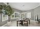 Dining area showcasing modern lighting, large windows with shutters, and a neutral color palette at 4615 Shark Dr, Bradenton, FL 34208
