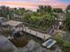 Waterfront property featuring a private dock with a boat lift, lush tropical landscaping, and a serene setting at 4615 Shark Dr, Bradenton, FL 34208
