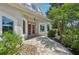 Inviting home entryway featuring double doors, a paver walkway, and lush landscaping at 4615 Shark Dr, Bradenton, FL 34208