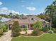 Charming single-story home featuring a beautiful lawn, lush landscaping, and a paver driveway at 4615 Shark Dr, Bradenton, FL 34208