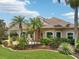 Beautifully landscaped home exterior showcasing a well-manicured lawn and mature palm trees at 4615 Shark Dr, Bradenton, FL 34208