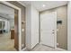 Hallway includes white cabinets, key rack, wood floor, and door to the outside at 4615 Shark Dr, Bradenton, FL 34208