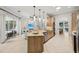 Open kitchen and living area with stainless appliances and tile flooring offers modern living at 4615 Shark Dr, Bradenton, FL 34208