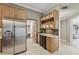 Kitchen with stainless refrigerator, stone countertops, custom cabinets and sink with wine glass storage at 4615 Shark Dr, Bradenton, FL 34208