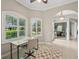 Bright home office with plantation shutters, neutral colors, and an arched doorway leading to the living area at 4615 Shark Dr, Bradenton, FL 34208