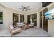 Inviting covered patio with tile flooring, ceiling fan, and comfortable seating area for relaxing and entertaining at 4615 Shark Dr, Bradenton, FL 34208