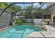 Beautiful pool and spa with lush landscaping, waterfall feature, and outdoor kitchen, perfect for outdoor enjoyment at 4615 Shark Dr, Bradenton, FL 34208