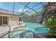 Screened-in pool area with spa, stone accents, and tropical landscaping offers a private and relaxing oasis at 4615 Shark Dr, Bradenton, FL 34208