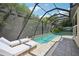Inviting screened-in pool area with lounge chairs, providing a perfect space for relaxation and recreation at 4615 Shark Dr, Bradenton, FL 34208
