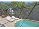 Relaxing screened-in pool area featuring lounge chairs and lush landscaping, creating a private outdoor retreat at 4615 Shark Dr, Bradenton, FL 34208