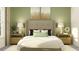 Inviting bedroom with a tufted headboard, decorative pillows, and ambient lighting, creating a serene retreat at 4765 Southern Valley Loop, Brooksville, FL 34601