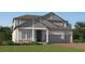 Charming two-story home with a three-car garage, beautiful stone accents, and a well-maintained lawn at 4765 Southern Valley Loop, Brooksville, FL 34601