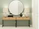Chic entryway with light wood console table, a round mirror, and complementing decorative lamps and vases at 4765 Southern Valley Loop, Brooksville, FL 34601